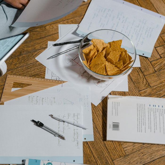 A cozy study session with notes, snacks, and digital devices, perfect for elearning.