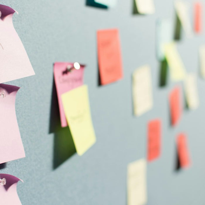 colorful sticky notes pinned to board