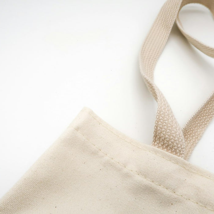 brown tote bag on white surface