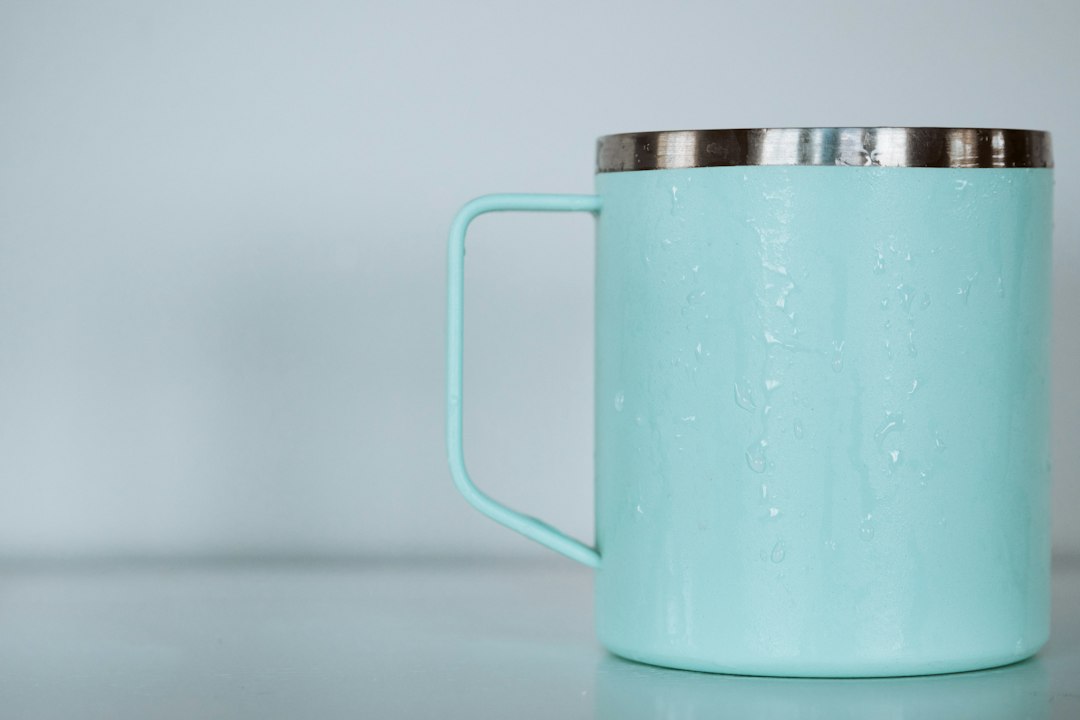 shallow focus photo of teal mug