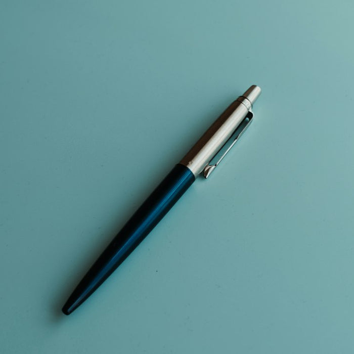 silver and blue click pen