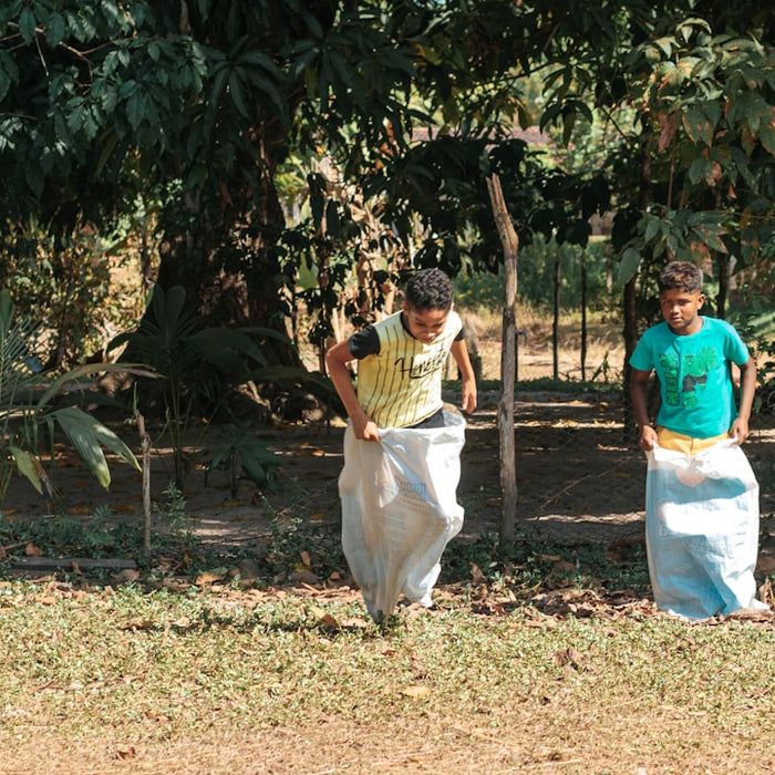 man in blue polo shirt and white pants standing beside woman in white dress during daytime
