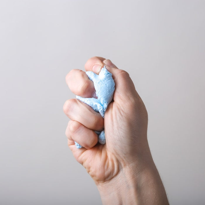 a person holding something in their left hand