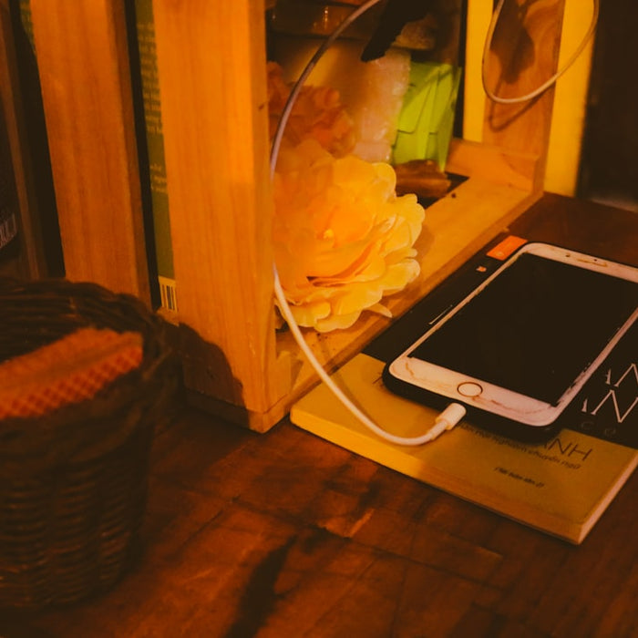 a cell phone sitting on top of a wooden table