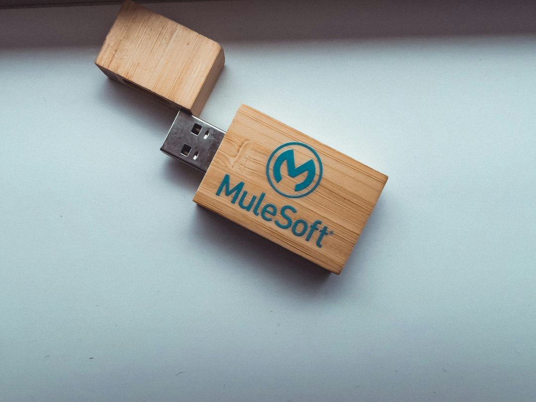 a wooden usb stick with a logo on it