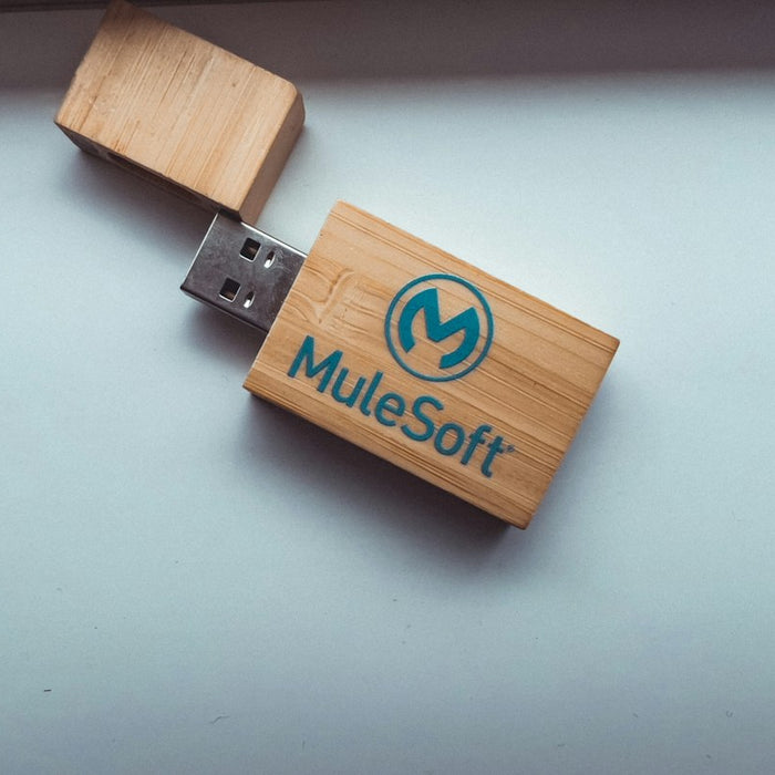 a wooden usb stick with a logo on it