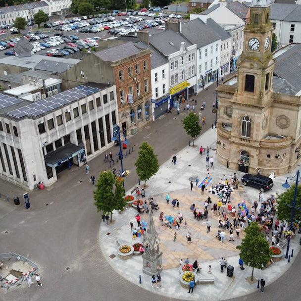 a large group of people gather in a city square