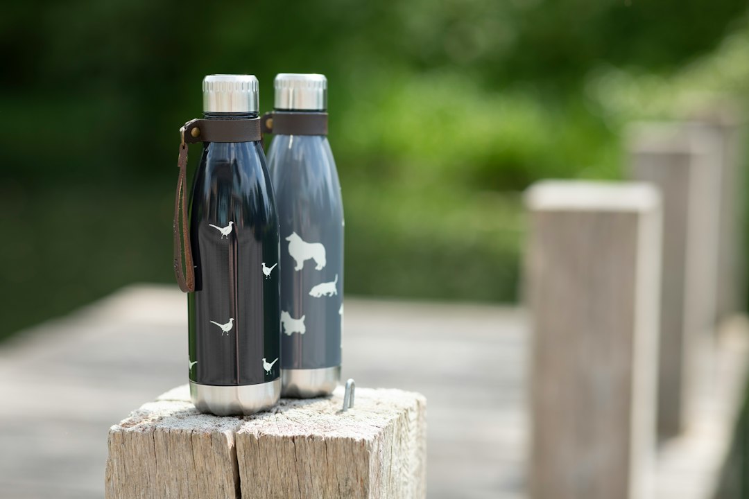 a couple of water bottles sitting on top of a wooden table