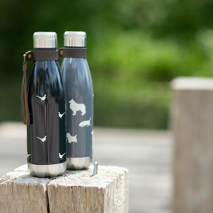 a couple of water bottles sitting on top of a wooden table