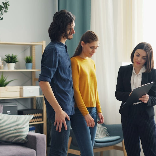 a man and a woman standing in a living room