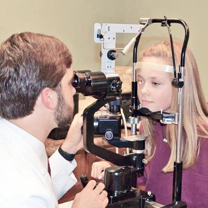 A man and a woman looking through a camera