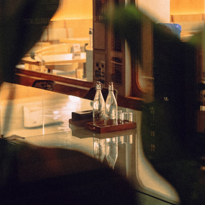 Two glass bottles and glasses on a tray