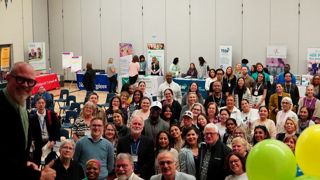 A large group of people gathered indoors at an event.