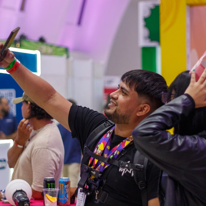 Man taking a selfie with a mask at an event.