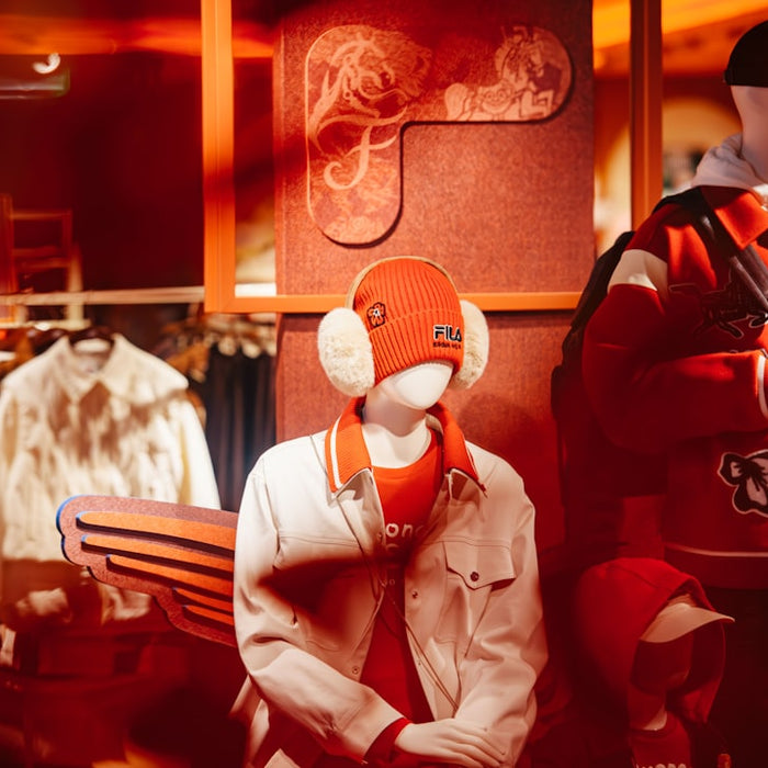 Mannequins display casual winter clothing in a store.