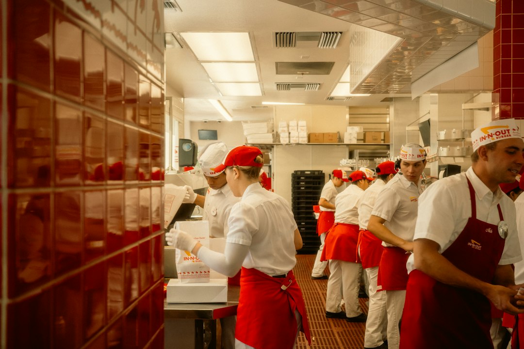 Restaurant staff in red aprons working in a kitchen