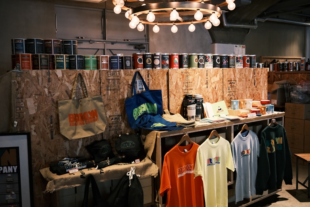 Shop interior featuring apparel, accessories, and cans on wooden displays
