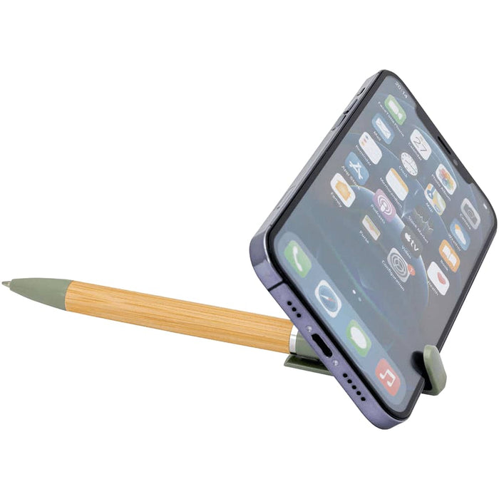 Delfina Phone Holder Pen - A bamboo pen with a green tip holds a smartphone at an angle, featuring various app icons on the screen.
