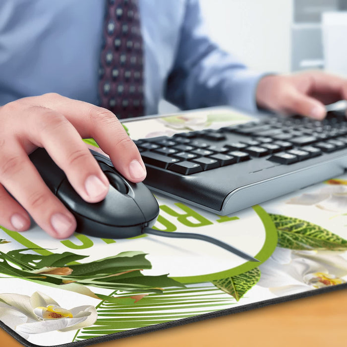 Jumbo Desk Mat - A hand using a black mouse on a floral-printed desk mat, with a keyboard visible in the background.