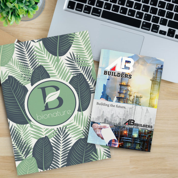 Camri Full Colour Notebook - Large - A large notebook with a leaf design in green and cream, alongside a brochure for a construction company.