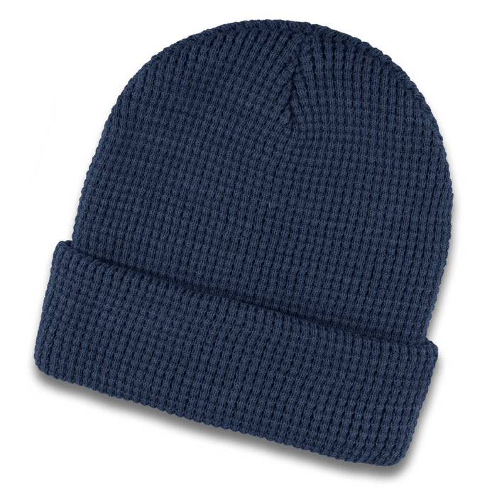 Galway Waffle Beanie - A navy blue waffle beanie featuring a textured knit design and a folded cuff. It has a small logo.