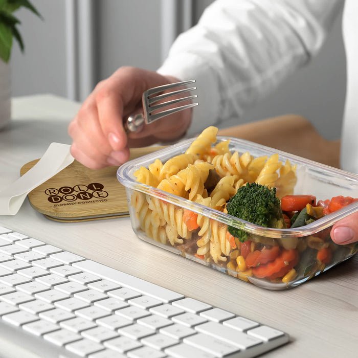 NATURA Iris Glass Lunch Box - A clear glass lunch box filled with pasta, vegetables, and a fork, placed on a table near a keyboard.