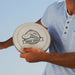 Choice Flyer - Large - A person holds a large grey disc with a disc golf design and logo, wearing a light blue shirt.