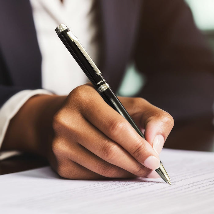 Swiss Peak Luzern Pen - A metal pen in black being held by a person writing on white paper, featuring a silver detailing and a branding logo.