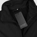 Swiss Peak Urban Softshell Jacket - A black softshell jacket with a zip closure and a tag featuring a logo.