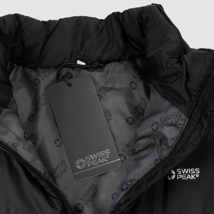 Swiss Peak Urban Puffer Vest - A black puffer vest with a high collar, featuring a tag and a subtle logo inside.