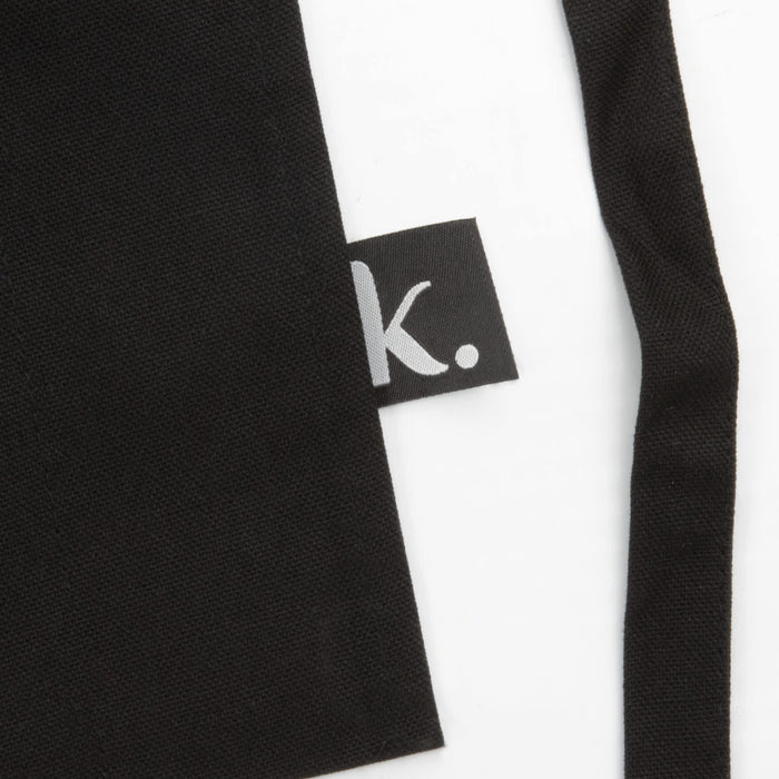 Keepsake Gardeners Set - A black gardening apron with a small logo tag on the side.