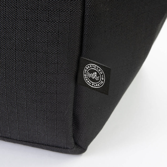 Oceana Recycled Cooler Bag - A black cooler bag featuring a logo, made from recycled materials. The textured fabric is visible in the image.