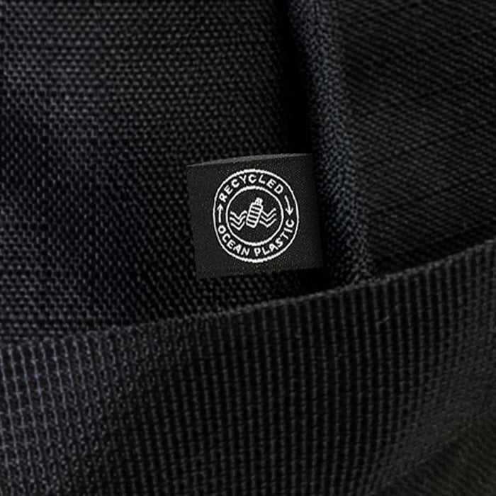 Oceana Recycled Duffle Bag - A black duffle bag made from recycled ocean plastic, featuring a small logo tag.