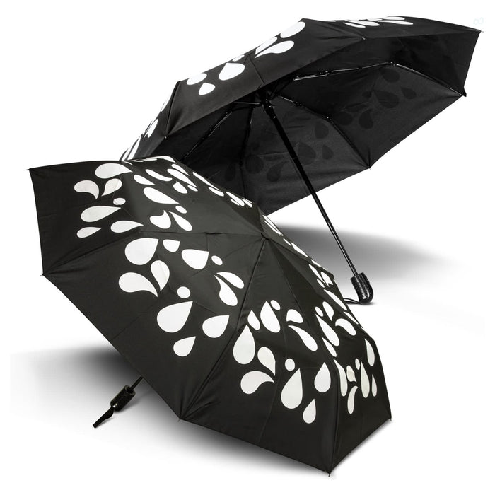 Colour Changing Compact Umbrella - A colour changing compact umbrella in black with white droplet patterns, featuring two opened canopies.