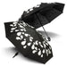 Colour Changing Compact Umbrella - A colour changing compact umbrella in black with white droplet patterns, featuring two opened canopies.