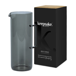 Keepsake Arlo Carafe - A drink bottle in a smoky grey colour, presented alongside a black box with branding.