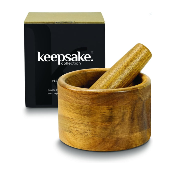Keepsake Mortar & Pestle - A wooden mortar and pestle set in a round bowl, displayed with a black box featuring a logo.