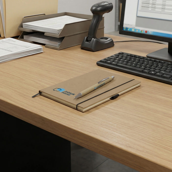 Kraft Notebook and Pen Gift Set - A kraft notebook with a pen rests on a wooden desk beside a computer and document organiser.