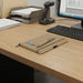 Kraft Notebook and Pen Gift Set - A kraft notebook with a pen rests on a wooden desk beside a computer and document organiser.