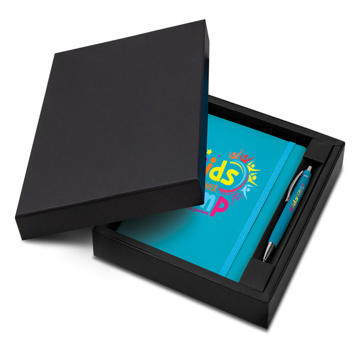 Omega Notebook and Pen Gift Set - A blue notebook and pen set displayed in a black gift box. The notebook features a logo and the set includes branding on the pen.