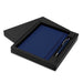 Omega Notebook and Pen Gift Set - A navy blue notebook and pen set displayed in a sleek black gift box. The box features a simple design and contains a logo.