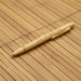 Moso Bamboo Pen - A bamboo pen with a natural finish, featuring a clip and branding. The background is made of bamboo material.