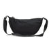 Selene Moon Bag - A black crossbody bag with a curved shape, featuring a zip closure and adjustable strap. It has a simple design with a logo.