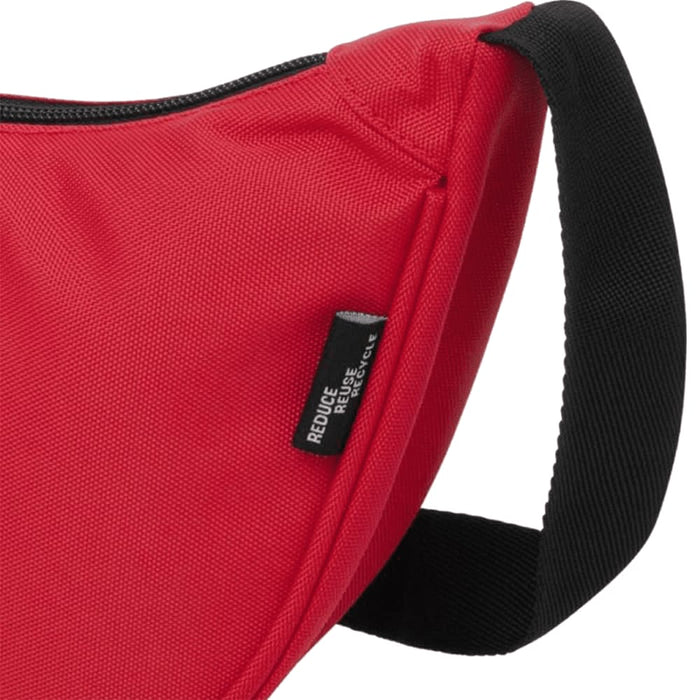 Byron Recycled Waist Bag 1.5L - A red waist bag with a black strap and a tag, featuring a textured fabric design.