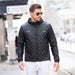 Swiss Peak Urban Unisex Windbreaker - A man wearing a black windbreaker with a hood, paired with sunglasses and light-coloured trousers. The jacket has a logo.