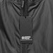 Swiss Peak Urban Unisex Windbreaker - A black windbreaker with a zipper and a tag featuring a logo. The fabric appears lightweight and smooth.