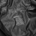 Swiss Peak Urban Unisex Windbreaker - A black windbreaker made of 100% polyester, featuring care instructions and a logo.