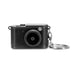 Candid Mini Camera - A mini camera in black with a textured finish and a keychain attachment. It features a round lens and a control dial.