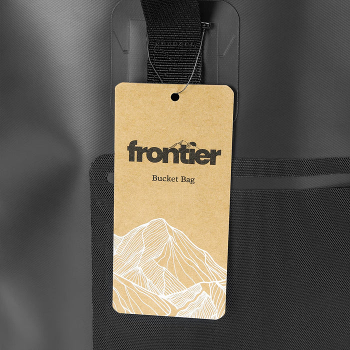 Frontier Bucket Bag - A grey bucket bag with a textured finish and a tag displaying its name and design elements.