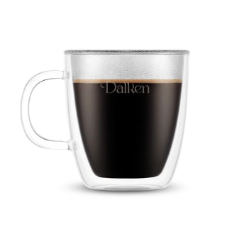 Bodum Bistro Double Wall Mugs - Set of 2 - A double wall mug made of clear glass, filled with dark liquid, featuring a handle and a logo.
